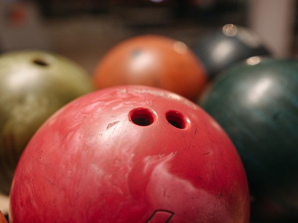 Drilled ball with finger and thumb holes; imported Motiv bowling balls still need a local driller