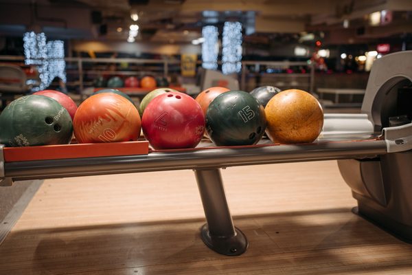 Bowling balls waiting on a ball return; Roto Grip bowling balls share racks like this in Malaysian centres
