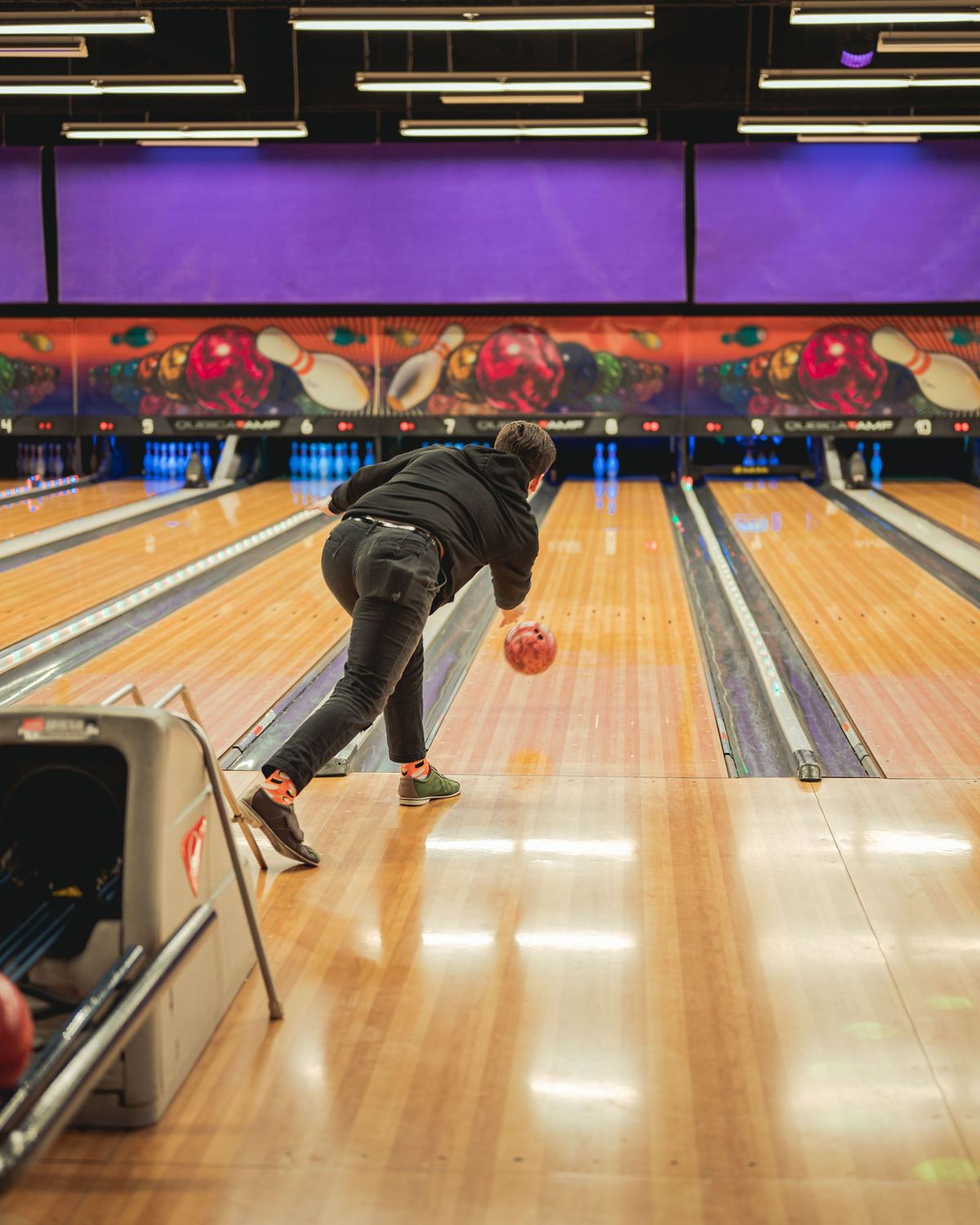 Bowler on the approach during delivery, showing good bowling etiquette by staying in their own lane