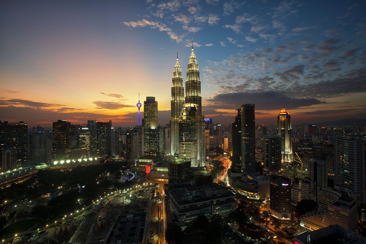 Kuala Lumpur skyline with the Petronas Twin Towers at dusk, the city where these bowling alleys sit