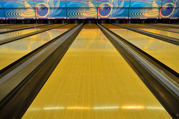 Polished wooden bowling lane seen from the approach, header photo for our privacy policy