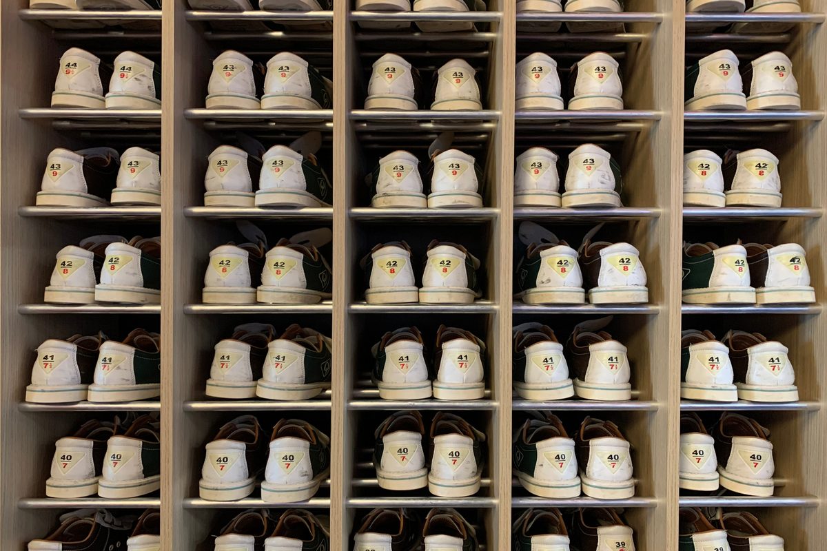 Shelves of rental bowling shoes at a bowling centre